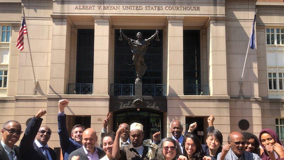 Mr Warfaa (centre) and his legal team at a Virginia courthouse