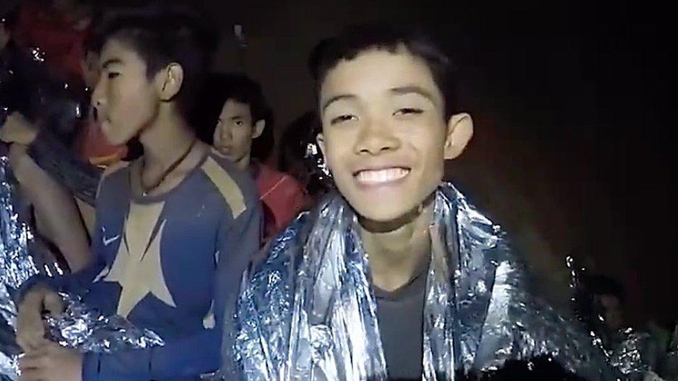 A video grab handout made available by Thai Royal Navy shows some of the members of a trapped soccer team in a section of Tham Luang cave in Khun Nam Nang Non Forest Park