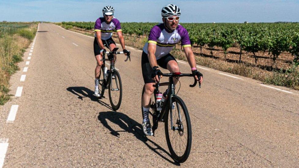 Two cyclists taking part in a bike ride