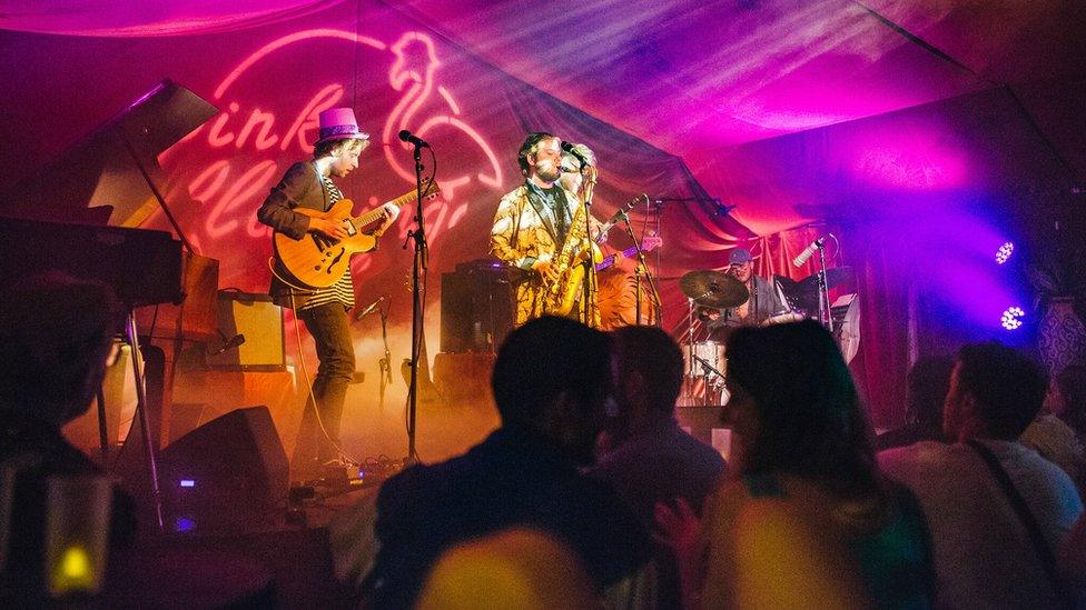 Musicians performing on stage at the Pink Flamingo Jazz club at Shambala Festival