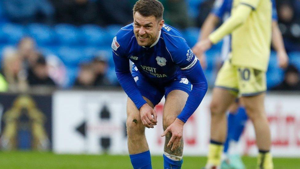 Aaron Ramsey clutches at his leg against Preston