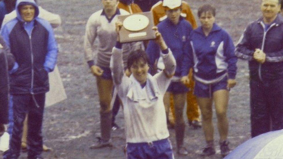 Carol Thomas lifting a trophy