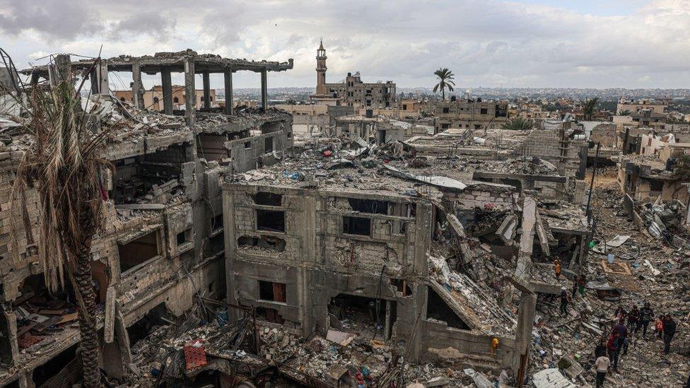 Destruction caused by Israeli strikes on their homes in the village of Khuzaa, near Abasan east of Khan Yunis near the border fence between Israel and the southern Gaza Strip on 27 November 2023