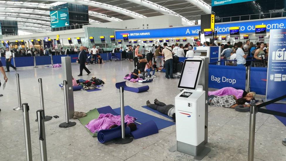 People resting at Heathrow Airport