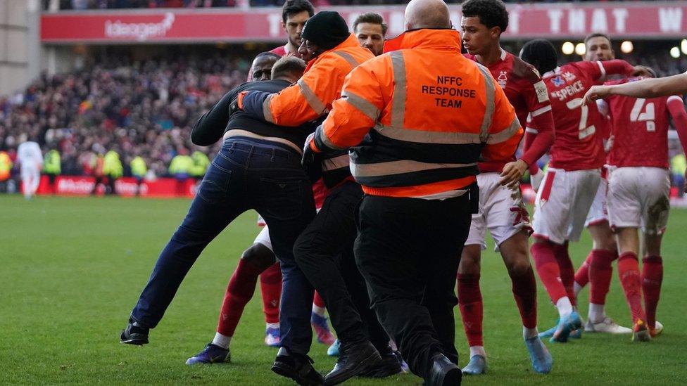 Man arrested after pitch invasion