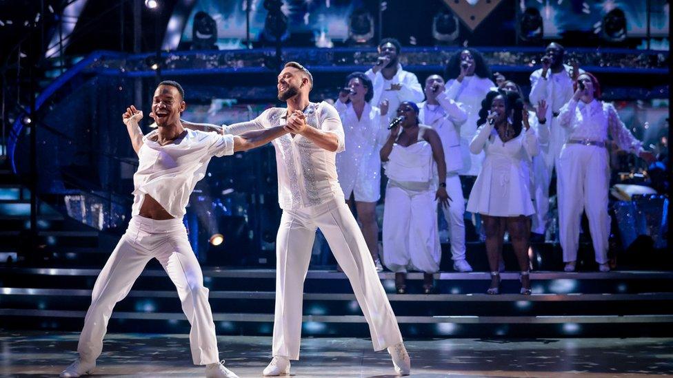 john and johannes performing their final dance with a gospel choir accompanying them