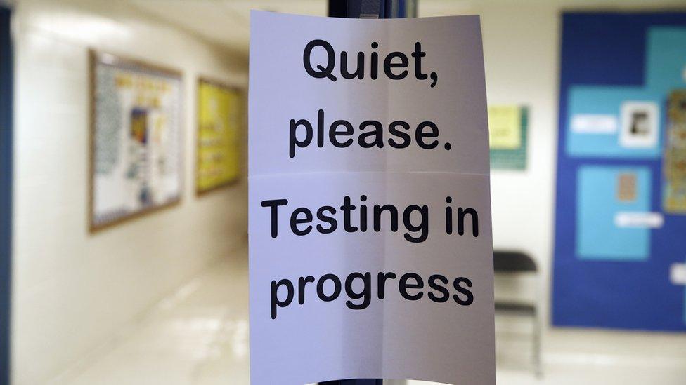 Sign in school warning that testing is in progress