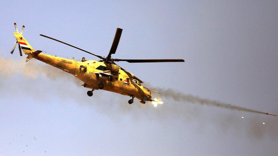 An Iraqi army attack helicopter fires at IS positions in Tal Afar city, northern Iraq, 25 August 2017