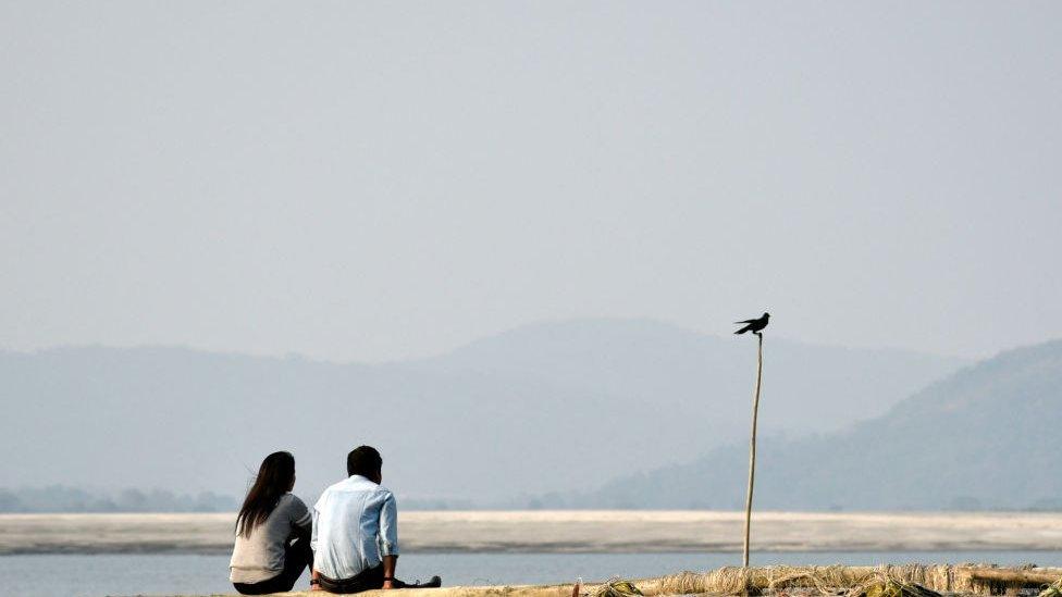 A representational photo of a couple at a beach in India.