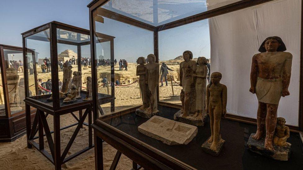 Statues were found in tombs at an archaeological site south of Cairo