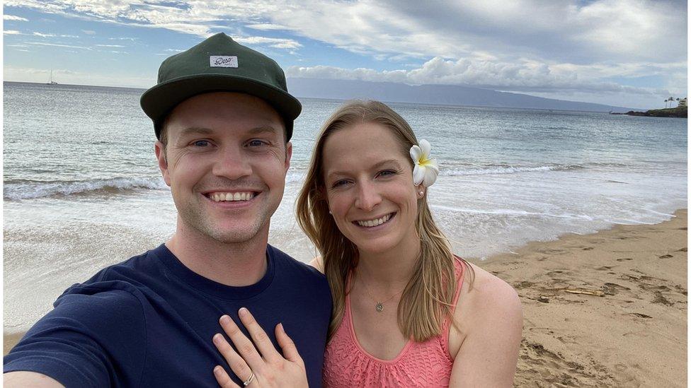 The couple smiling on the beach