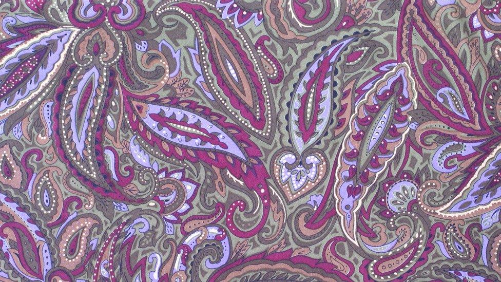 Purple paisley pattern on fabric