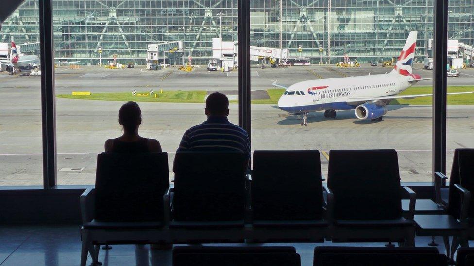 Airline passengers at Heathrow Airport terminal Five