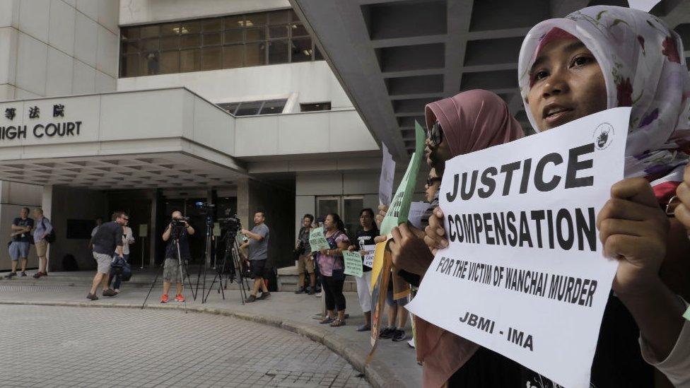 Migrant workers alliance group holds protest outside the High Court in Hong Kong, Monday, Oct 24, 2016