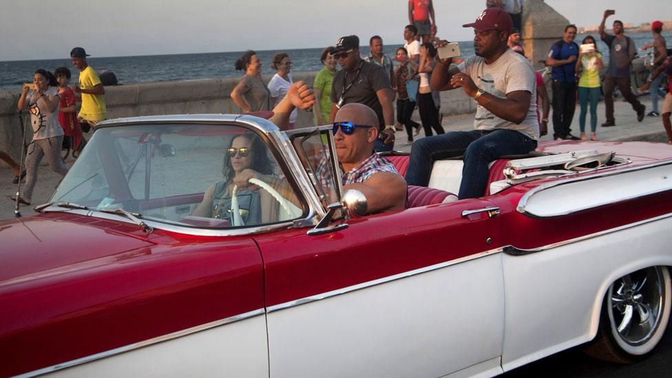 Michelle Rodriguez and Vin Diesel driving in Cuba with an unidentified man