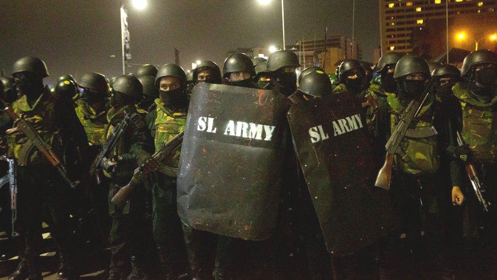 Members of Sri Lankan security forces patrol the Presidential Secretariat on July 22, 2022