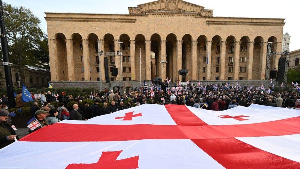 Georgian opposition activists outside parliament in Tbilisi