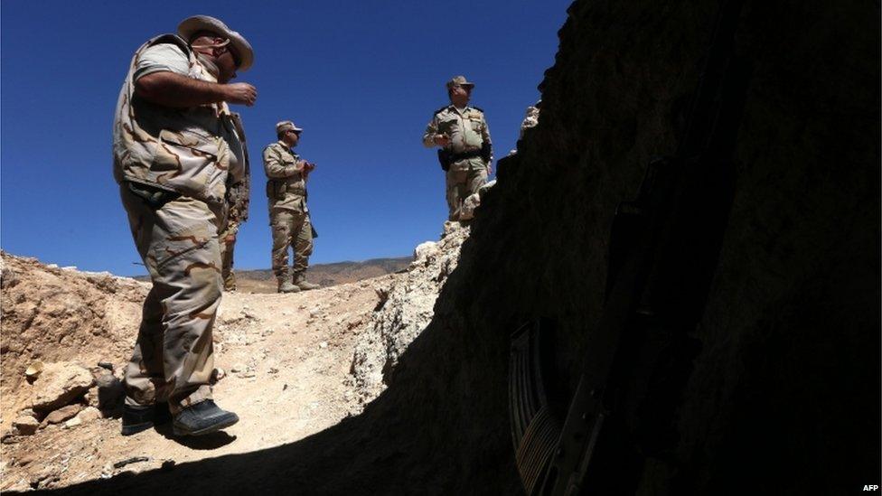 Iraqi Kurdish Peshmerga fighters guard a position at the frontline of fighting against Islamic State (IS) group"s militants near the northern Iraqi town of Sinjar, west of the city of Mosul on 17 August 2015