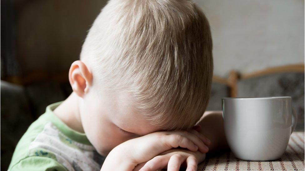 A child with his head in his hands