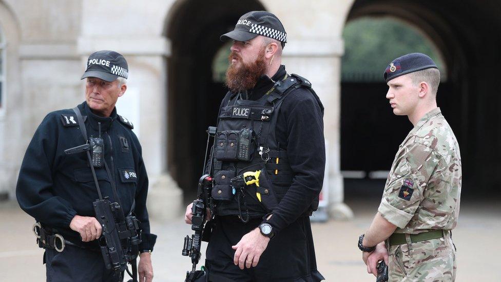 Armed police and a soldier outside Horse Guard's Parade