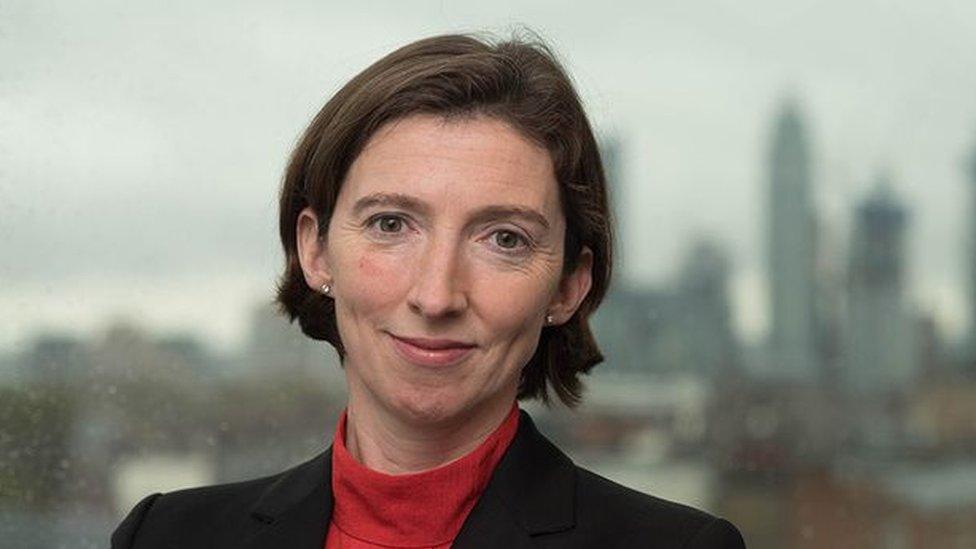 A head shot of Lindy Cameron with a city skyline background