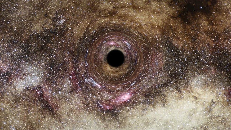 An artist's impression of a black hole surrounded by stars