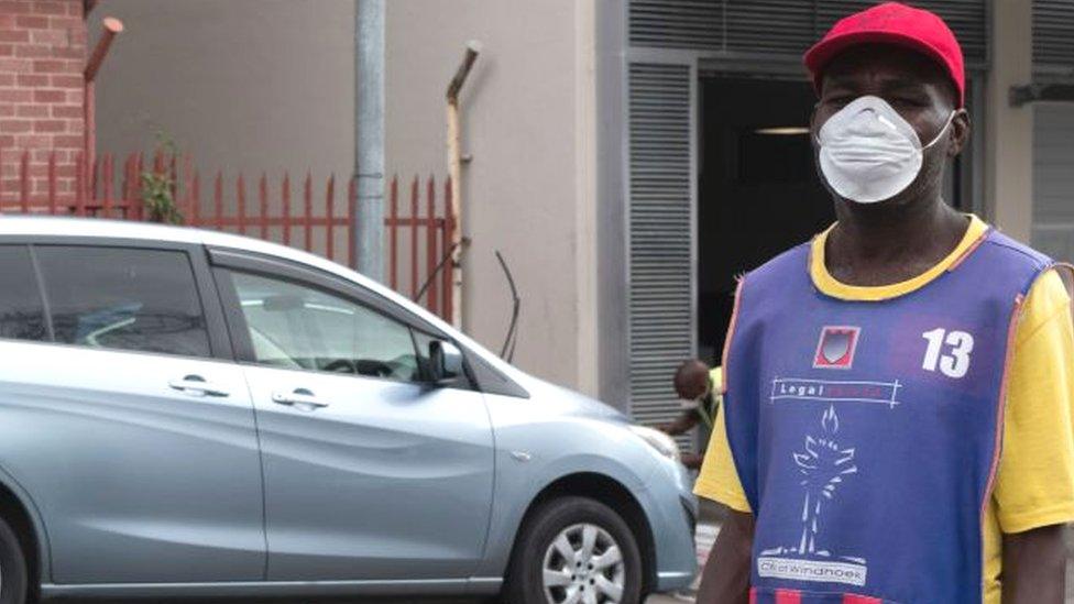 Man with a mask near a car