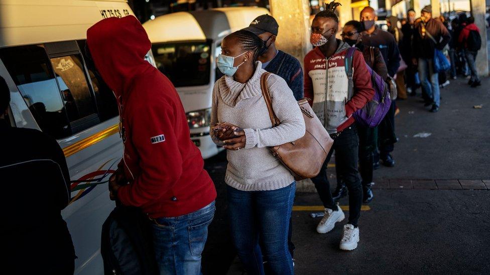 Commuters queue to use buses to work