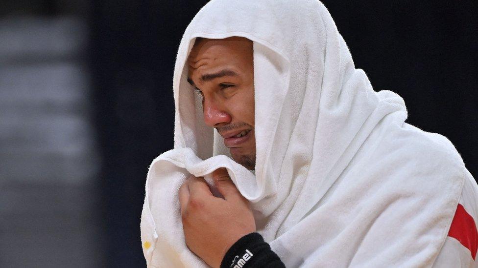 Egypt's pivot Mohamed Mamdouh Shebib reacts after being defeated by Spain at the end of the men's bronze medal handball match