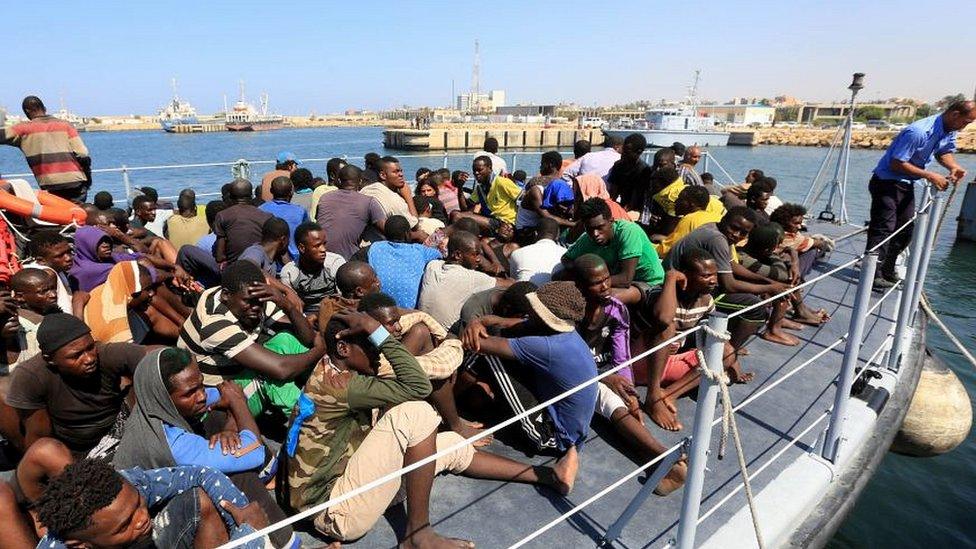 Migrants picked up by the Libyan coastguard on the approach to Tripoli port