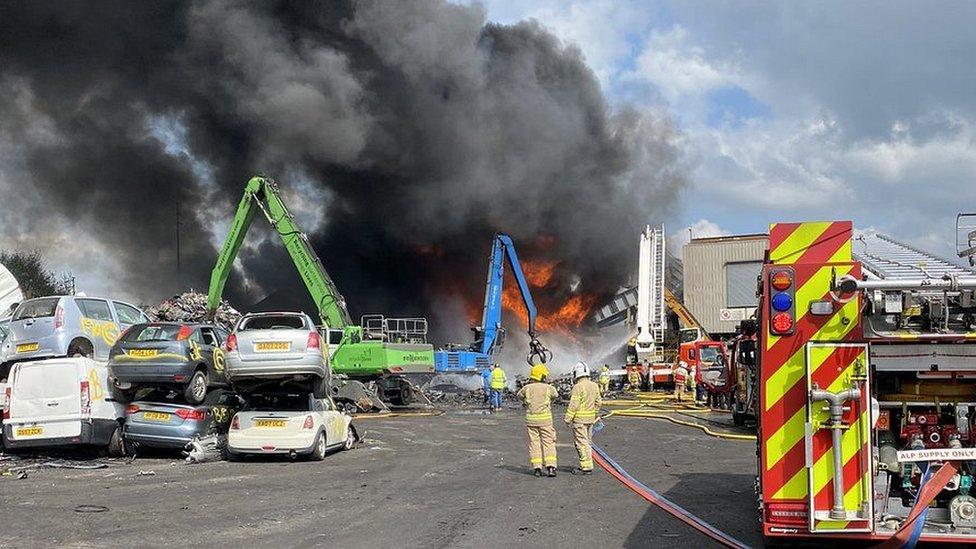 fire at the site with firefighters around the scene