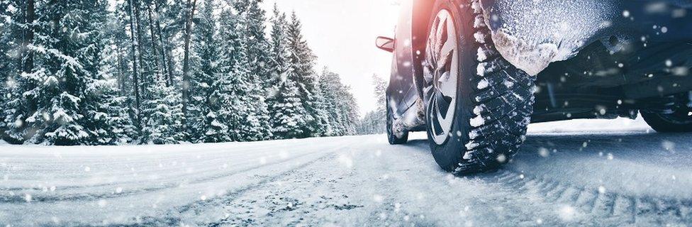 Car driving in light snow