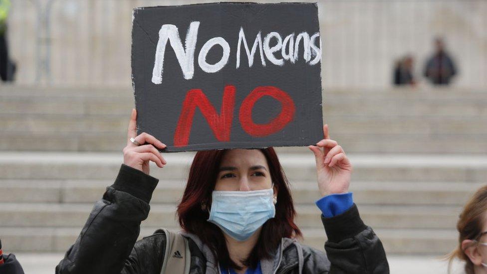 A woman protesting against violence towards women in Trafalgar Square, London