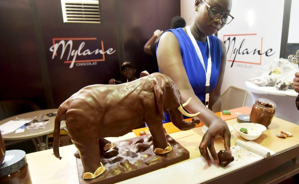 A woman sets up a chocolate on the work bench during an exhibition at the opening day of the National Chocolate and Cocoa Day in Abidjan, Ivory Coast, September 30, 2019.