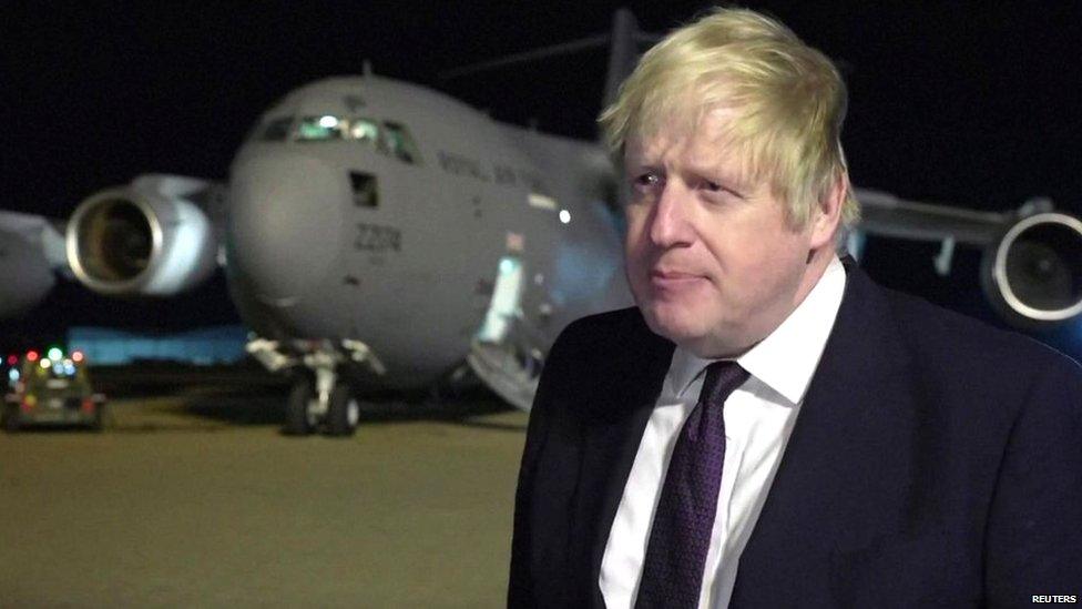 Boris Johsnon standing in front of a plane