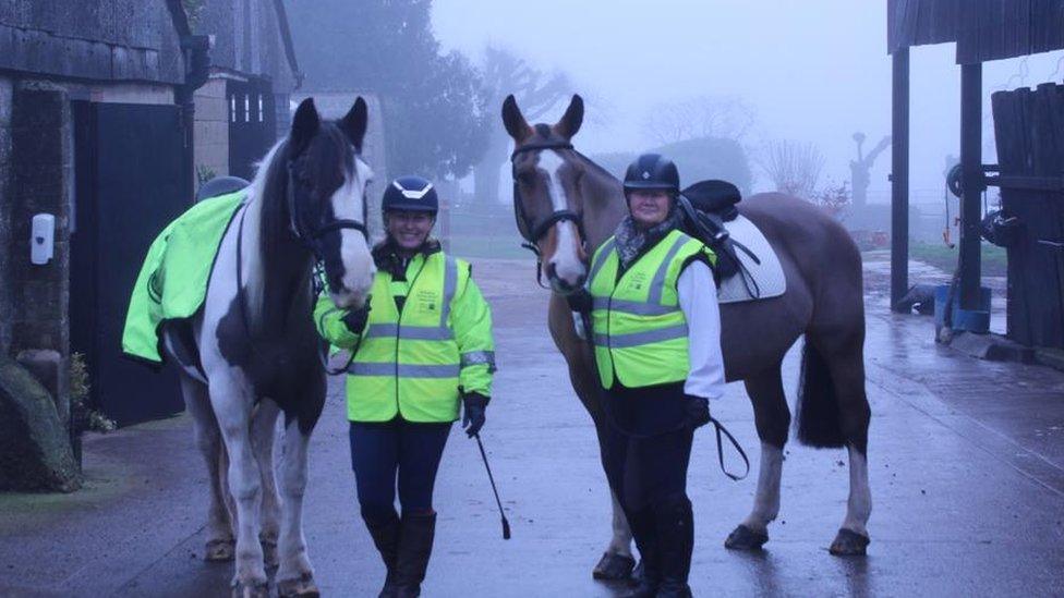 Volunteers riding horses