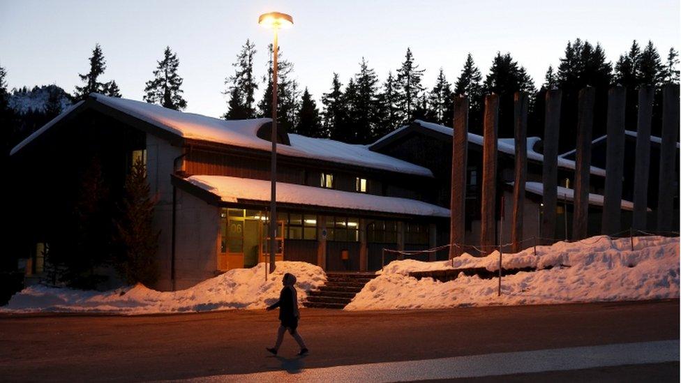 A refugee walks outside in the Swiss Army Camp Glaubenberg which is used as a centre for refugees on the Glaubenberg mountain in central 3 Switzerland, 2015