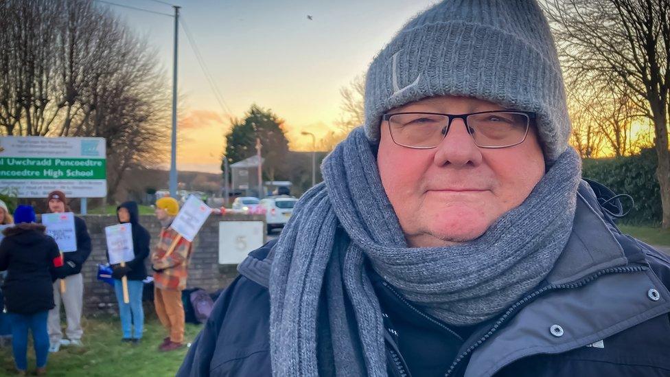 Mark Adams standing in front of a picket line