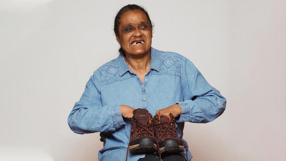 Wendy Enfields holding her hiking boots