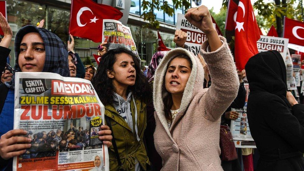 Turkish protesters outside the headquarters of Bugun newspaper and Kanalturk television station in Istanbul during a demonstration against the Turkish government's crackdown on media outlets