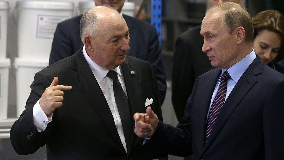 Russian President Vladimir Putin (R) talks to billionaire, businessman and owner of Acron Group Viatcheslav Kantor (L) while visiting the Acron plant