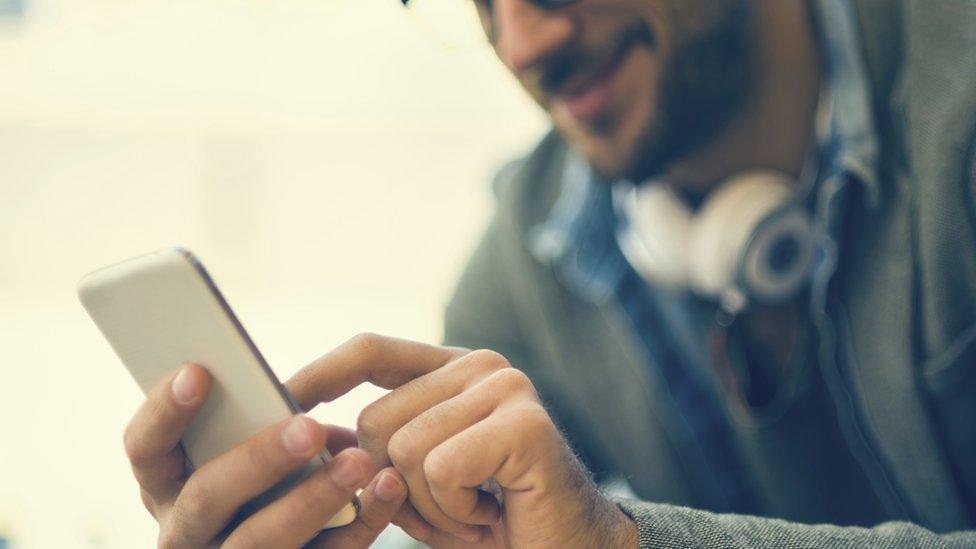 generic smart phone held by a man