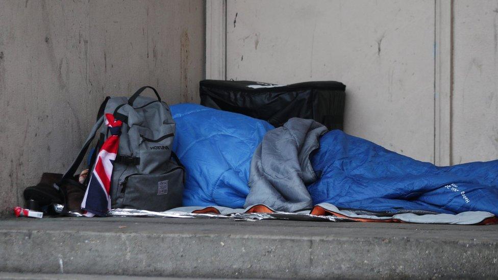 A homeless person in a sleeping bag on the streets in the UK