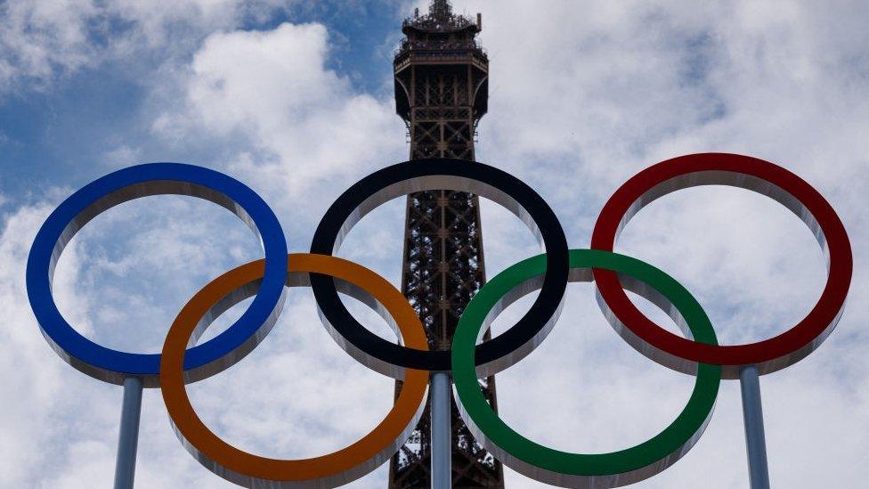 A picture of the Olympic rings in front of the Eiffel Tower in Paris