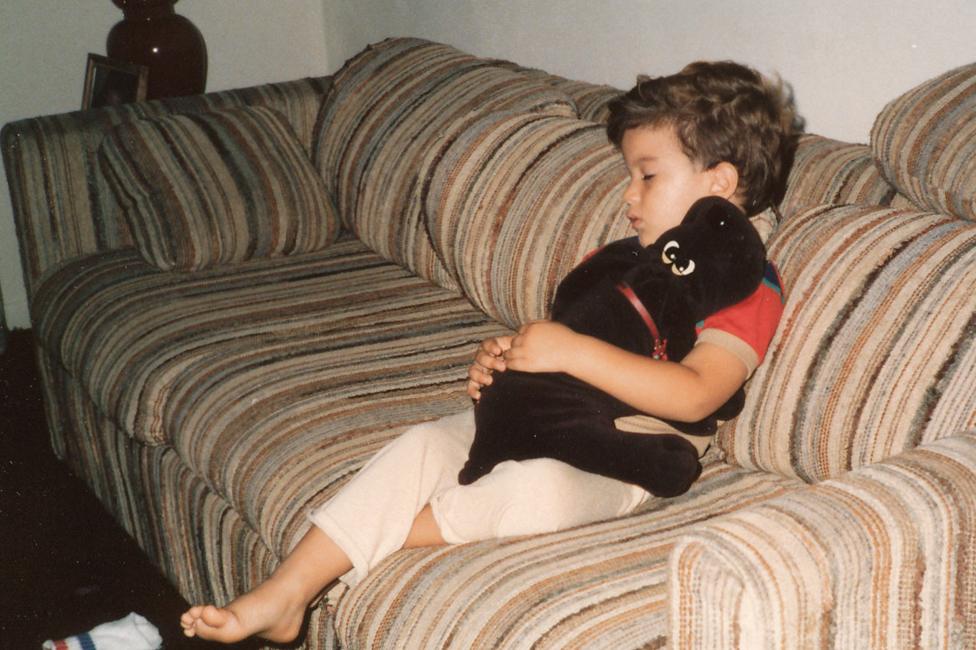 Salinas as a child, sleeping on a sofa