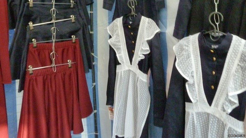 The girls' uniforms hanging up in a shop