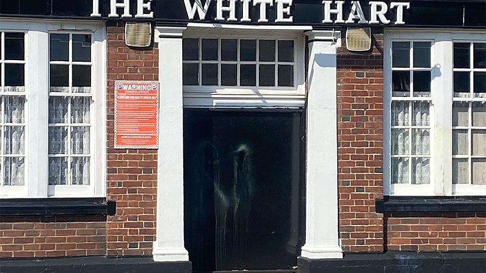 Paint smears on door of White Hart Inn