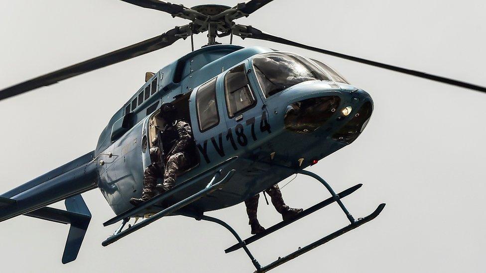 Security forces overfly Venezuela"s third city, Valencia, as anti-government activists demonstrate, 6 August