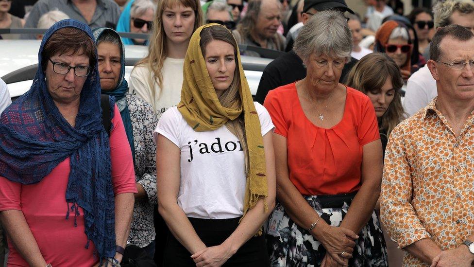 Local residents with head scarfs gather for the call to prayer and the moments silence at Masjid Umar mosque