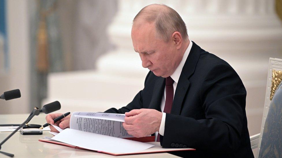 Russian President Vladimir Putin signs decrees on the recognition of two breakaway republics in Ukraine